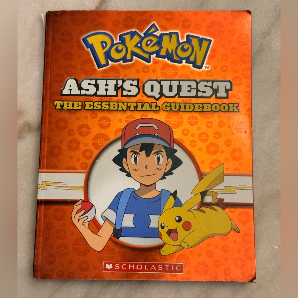 Scholastic Ash's Quest Guide Book - Orange Cover